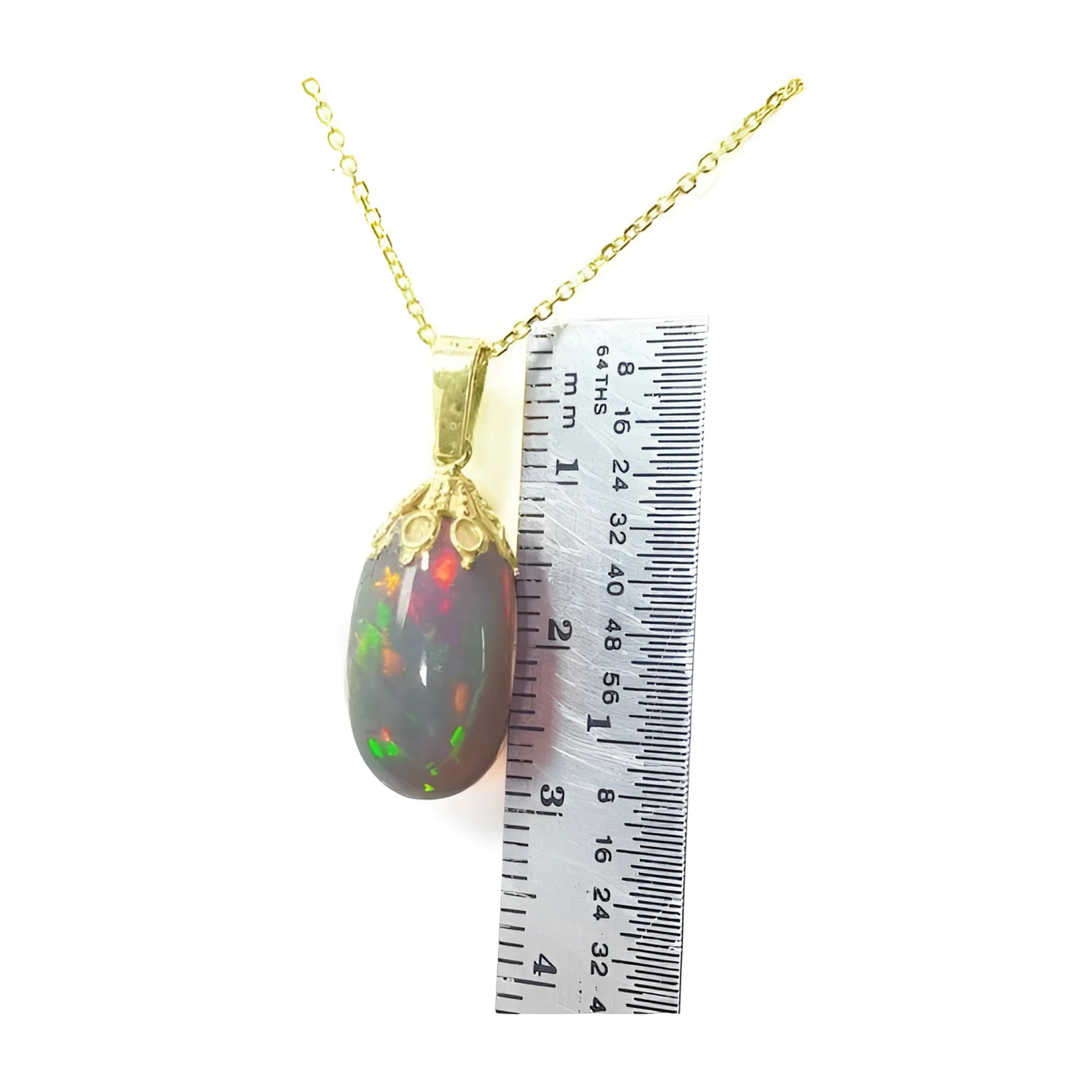 Ethiopian Welo opal pendant with vibrant red fire in 14k yellow gold, shown with a ruler.