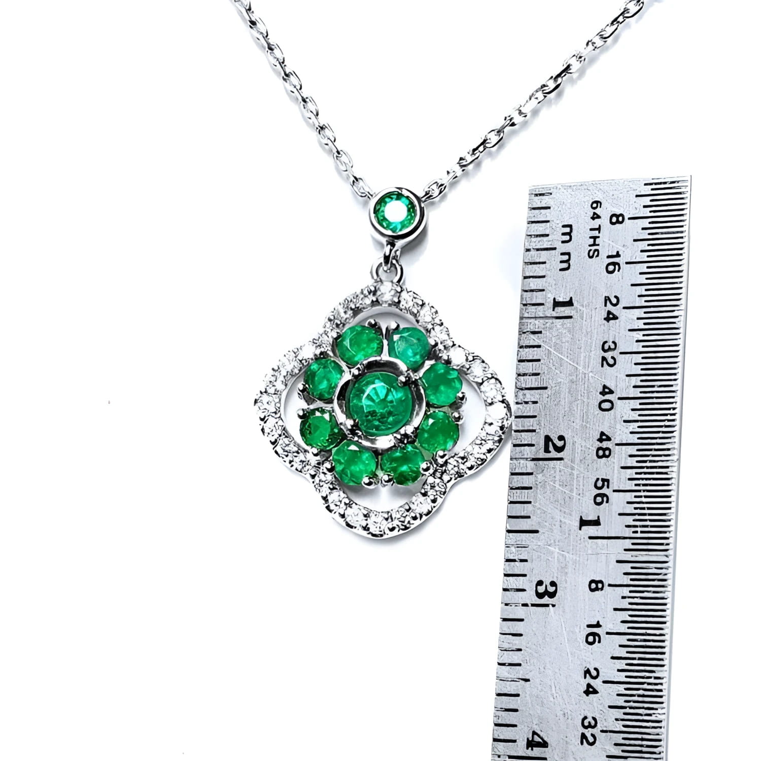 14K white gold cluster necklace with natural Colombian emeralds in a clover design, surrounded by diamonds.
