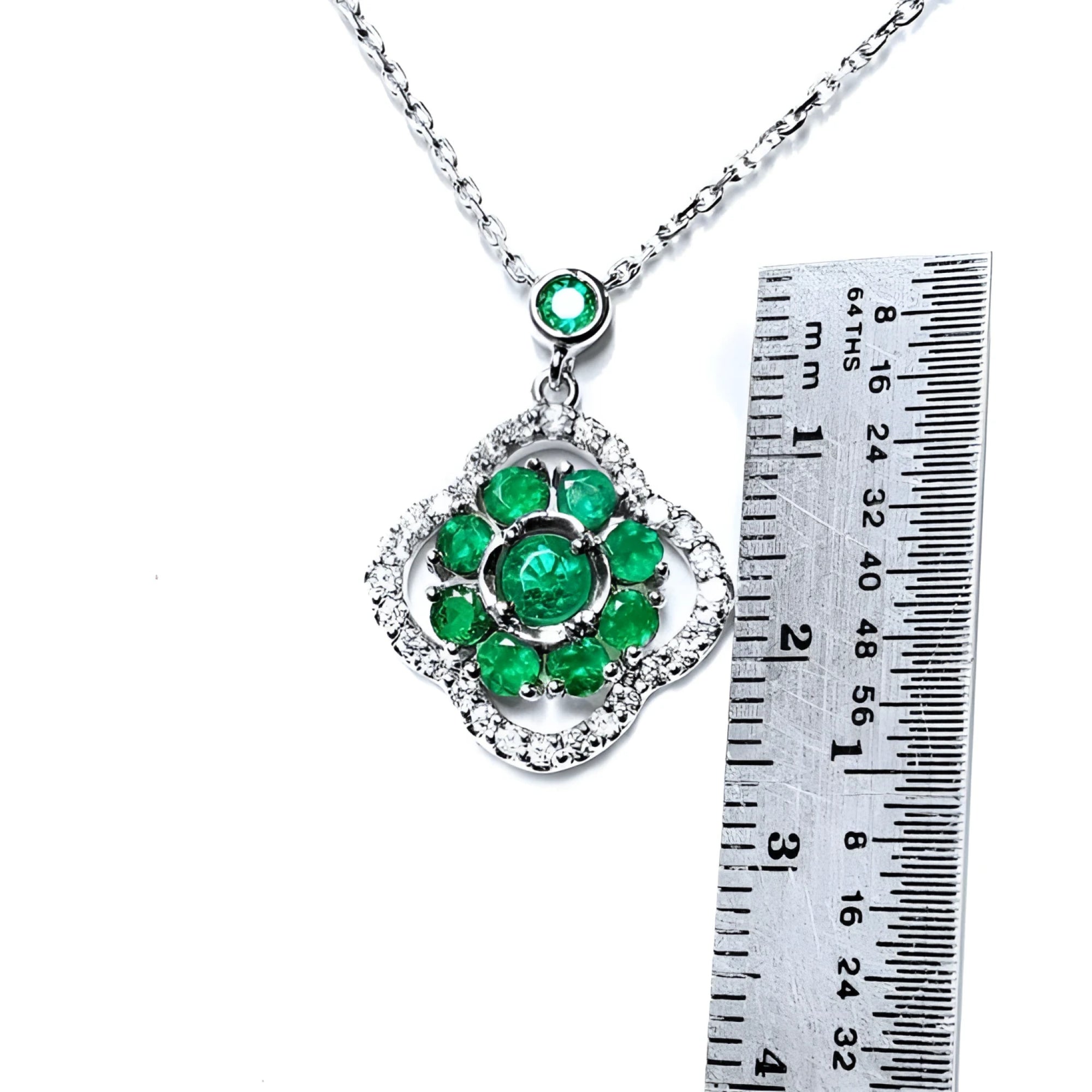 14K white gold cluster necklace with natural Colombian emeralds in a clover design, surrounded by diamonds.