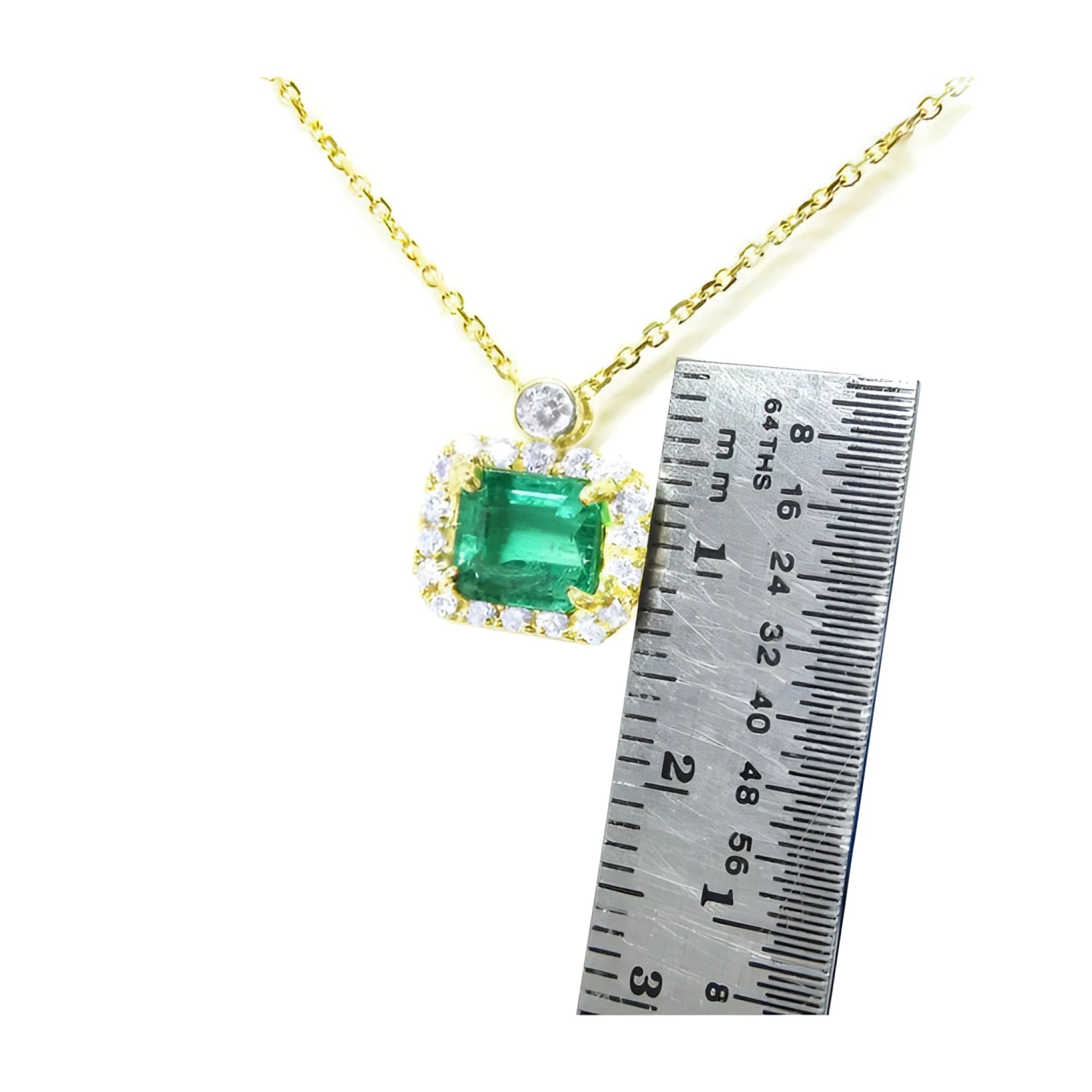 1.31 ct emerald-cut Muzo Colombian emerald necklace with diamonds in 14K yellow gold.