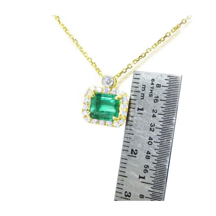 1.31 ct emerald-cut Muzo Colombian emerald necklace with diamonds in 14K yellow gold.