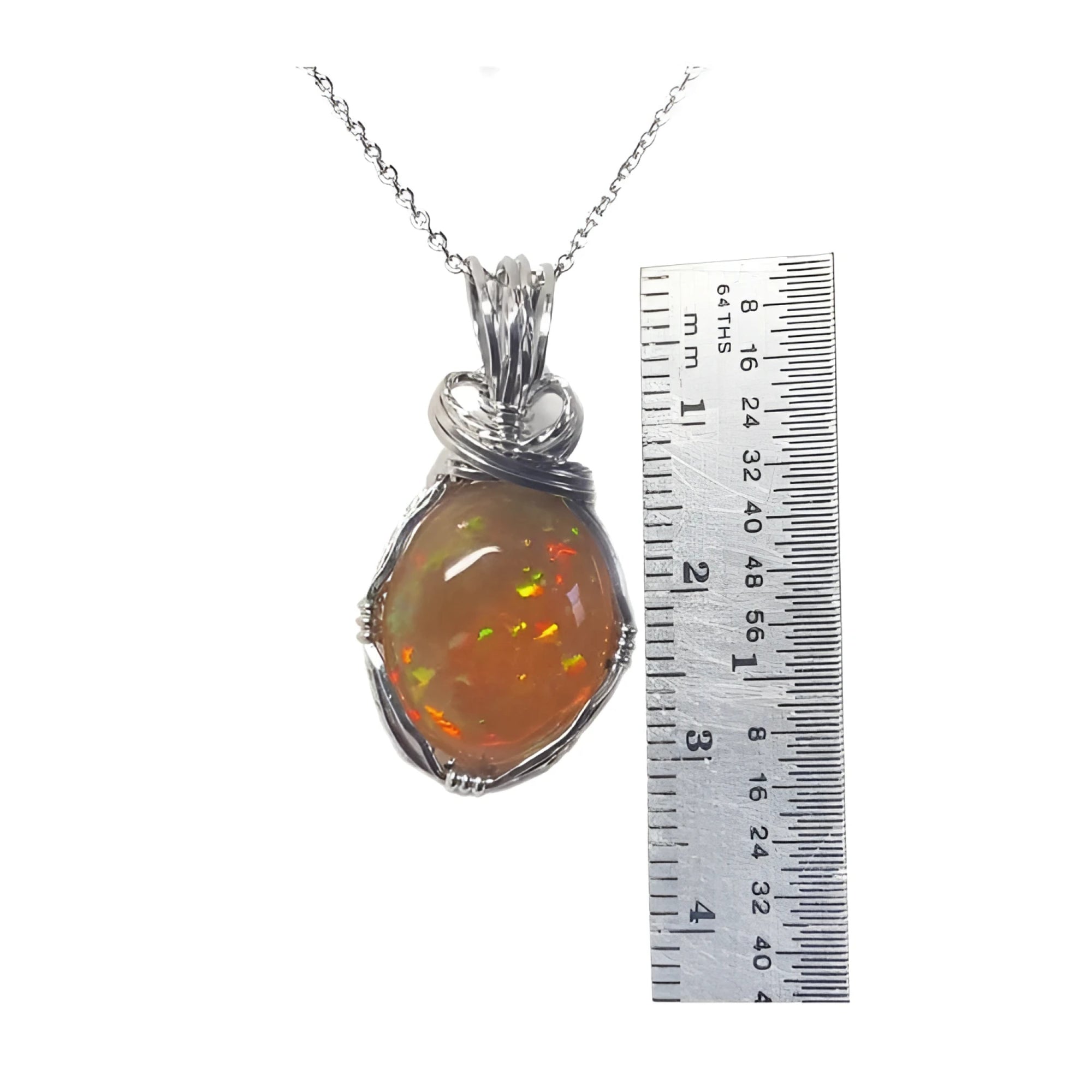 Oval Ethiopian opal pendant with vibrant play of colors and brown pinpoint fire in silver wire wrap.