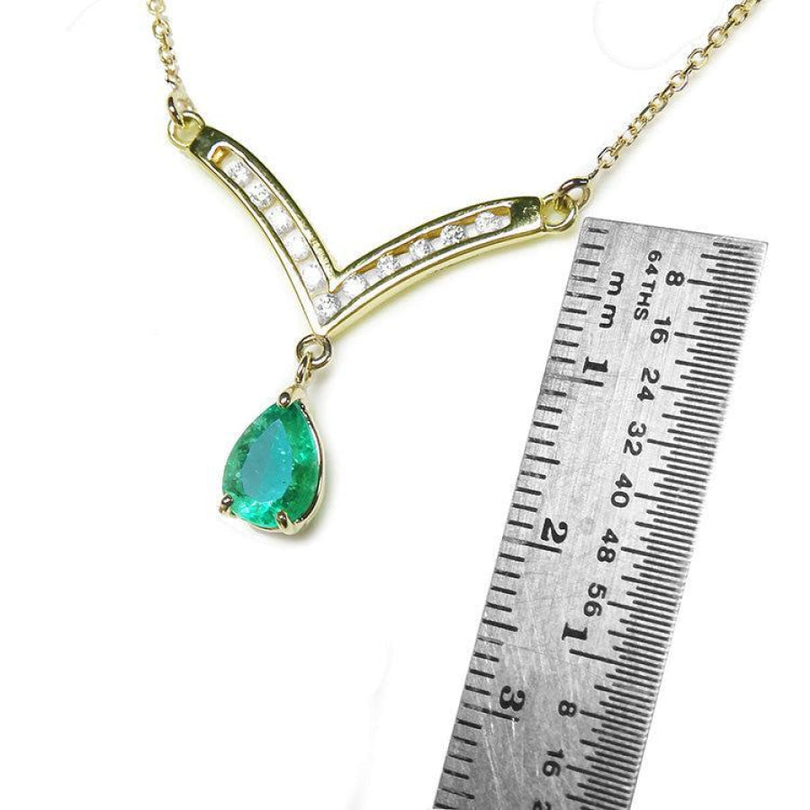1.01 carat pear cut emerald necklace with accent diamonds on a 14K yellow gold V-chevron.