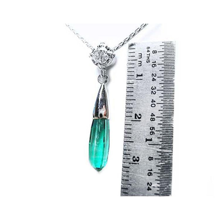 Colombian emerald briolette necklace with a bluish-green drop pendant and diamond slider on 14K white gold chain, next to a ruler.