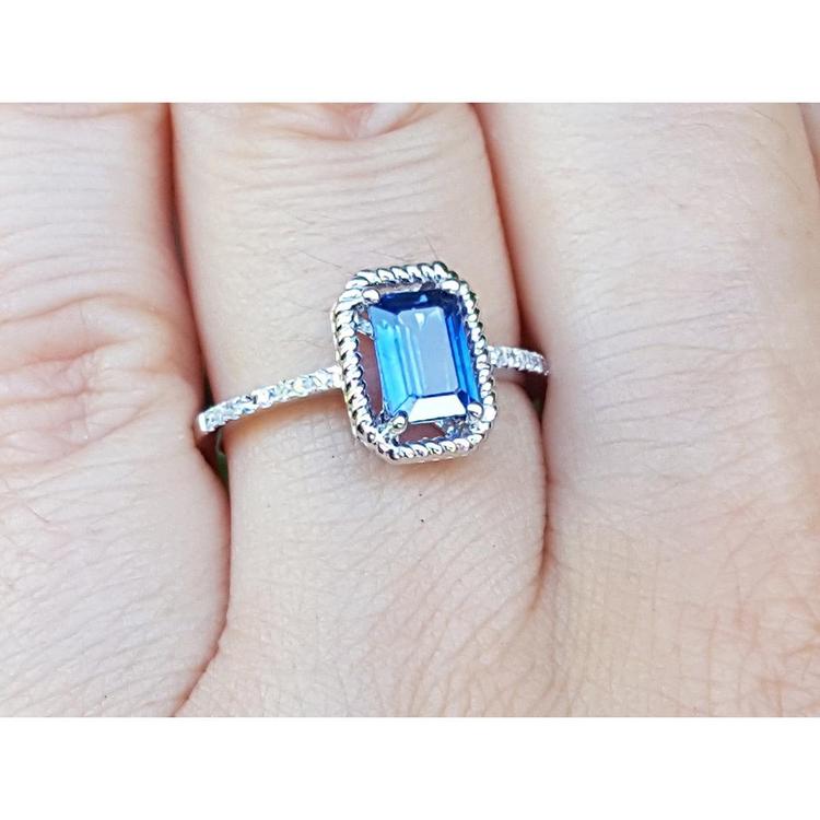 Women's sapphire solitaire ring medium light blue accent diamonds 14K white gold, on finger