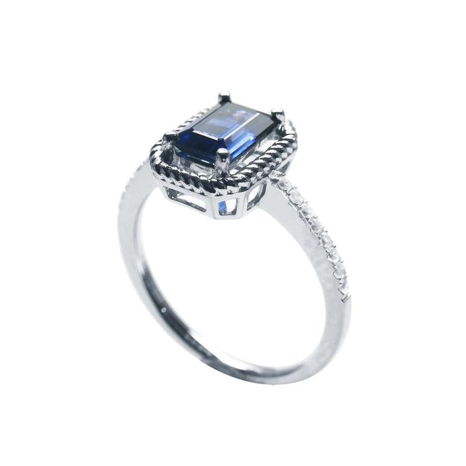 14K white gold solitaire ring with an emerald cut blue sapphire, rope frame, and accent diamonds.