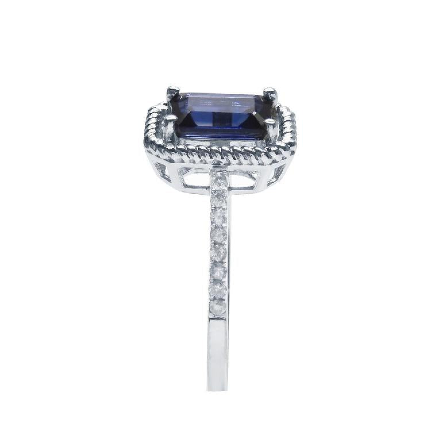 1.03 ct. emerald cut blue sapphire solitaire ring in 14K white gold with rope frame and diamond accents.