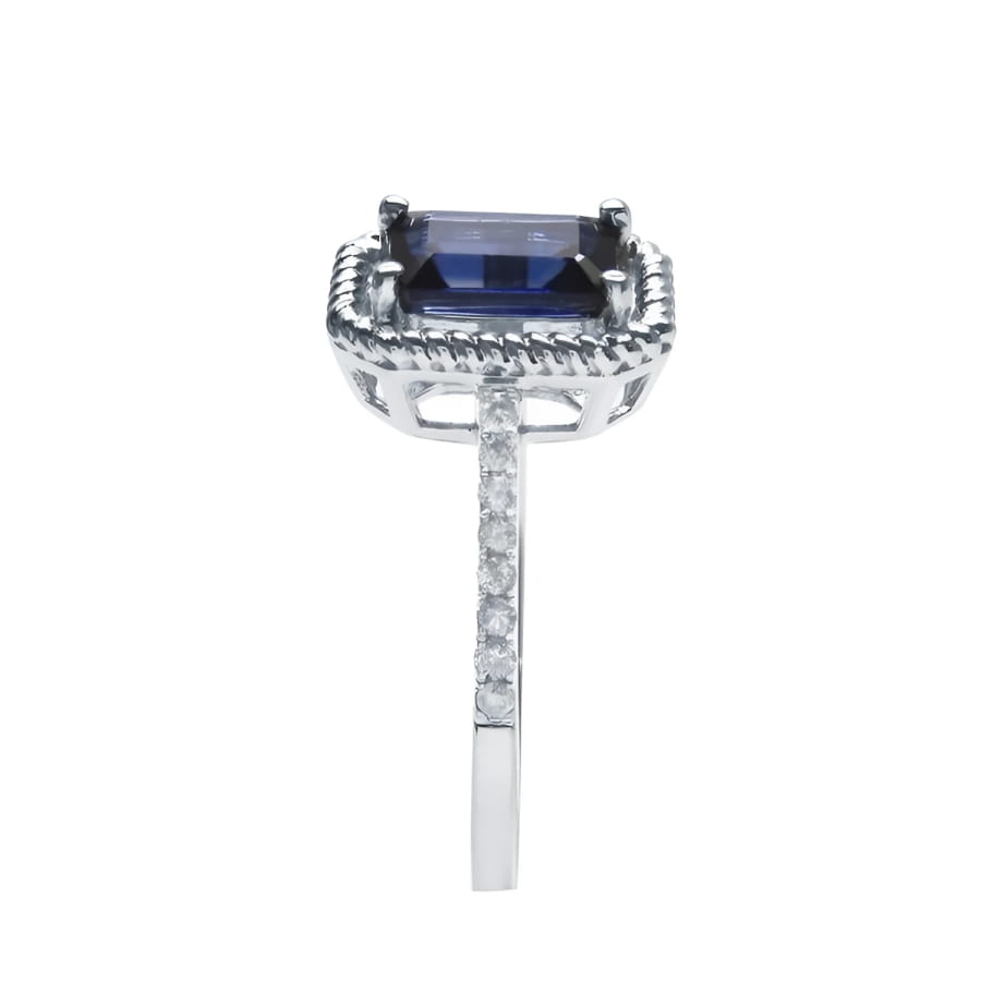 1.03 ct. emerald cut blue sapphire solitaire ring in 14K white gold with rope frame and diamond accents.