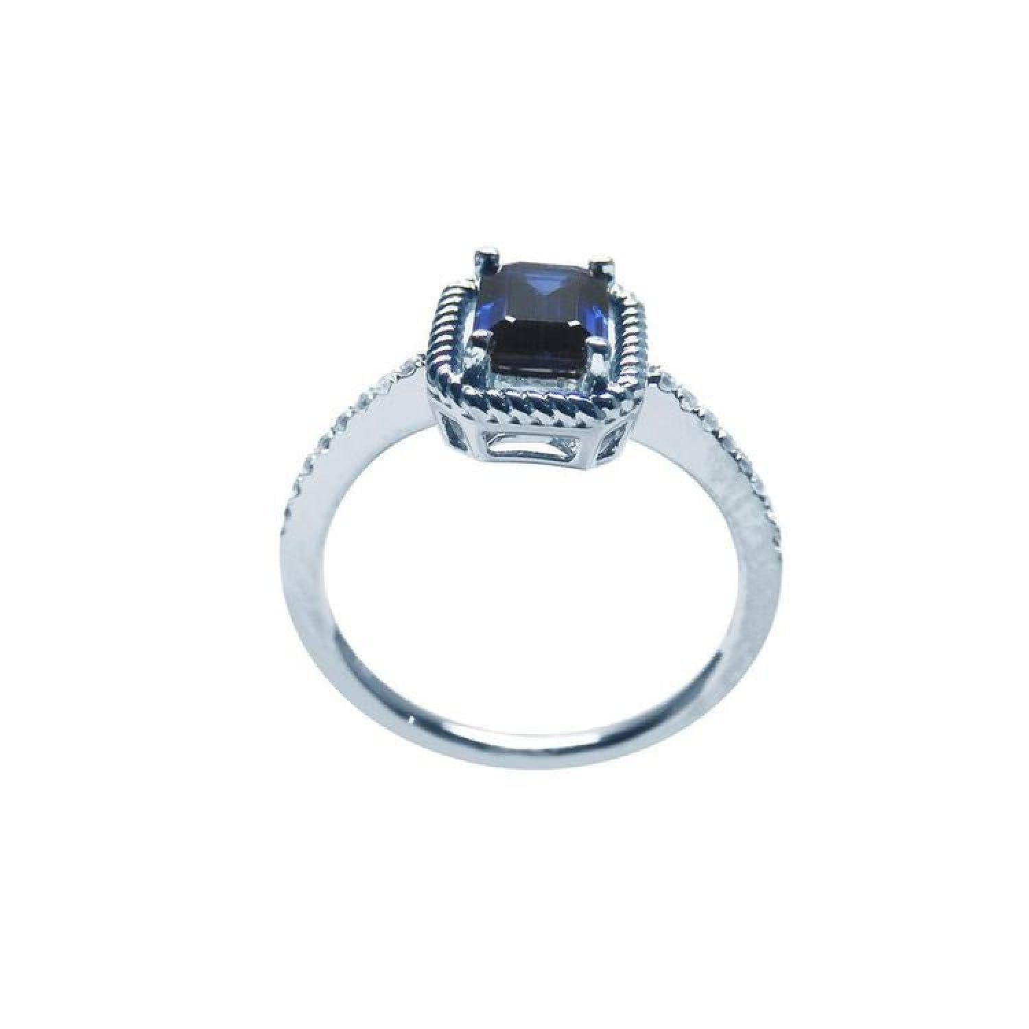 1.03 ct. emerald cut blue sapphire solitaire ring in 14K white gold with rope frame and accent diamonds.