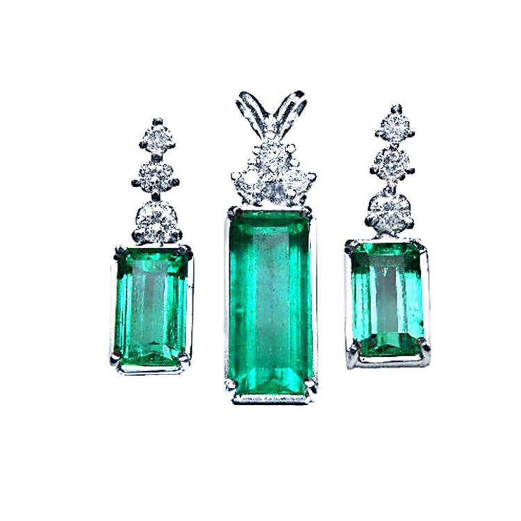 Set of natural emerald gemstone earrings with diamond tops on a front position top view