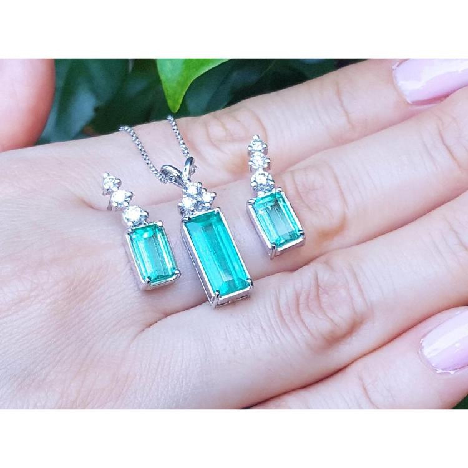 Emerald earrings and pendant set with accent diamonds in 14K white gold.