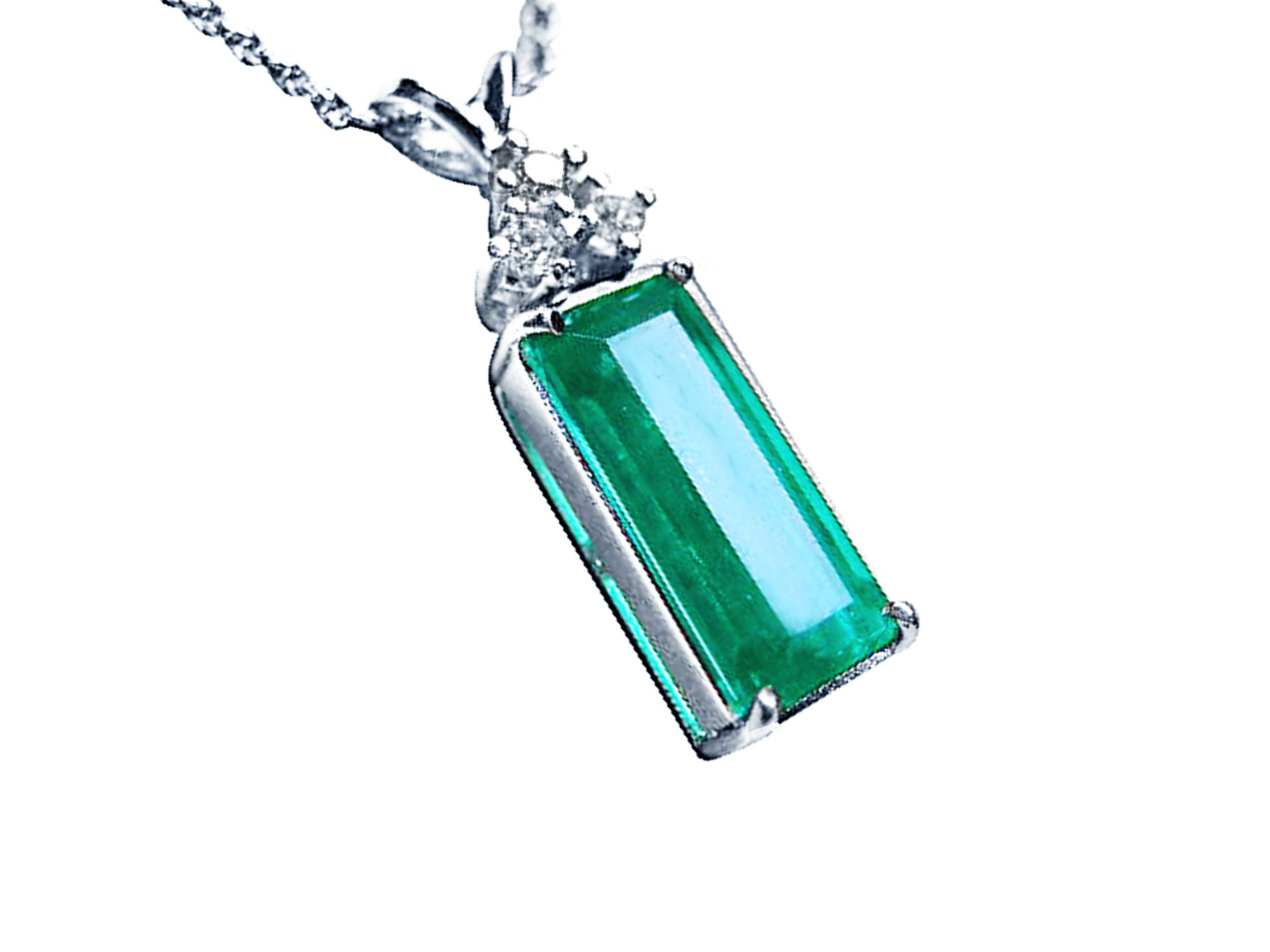 Right side top view of an emerald gemstone pendant pending of a white gold chain