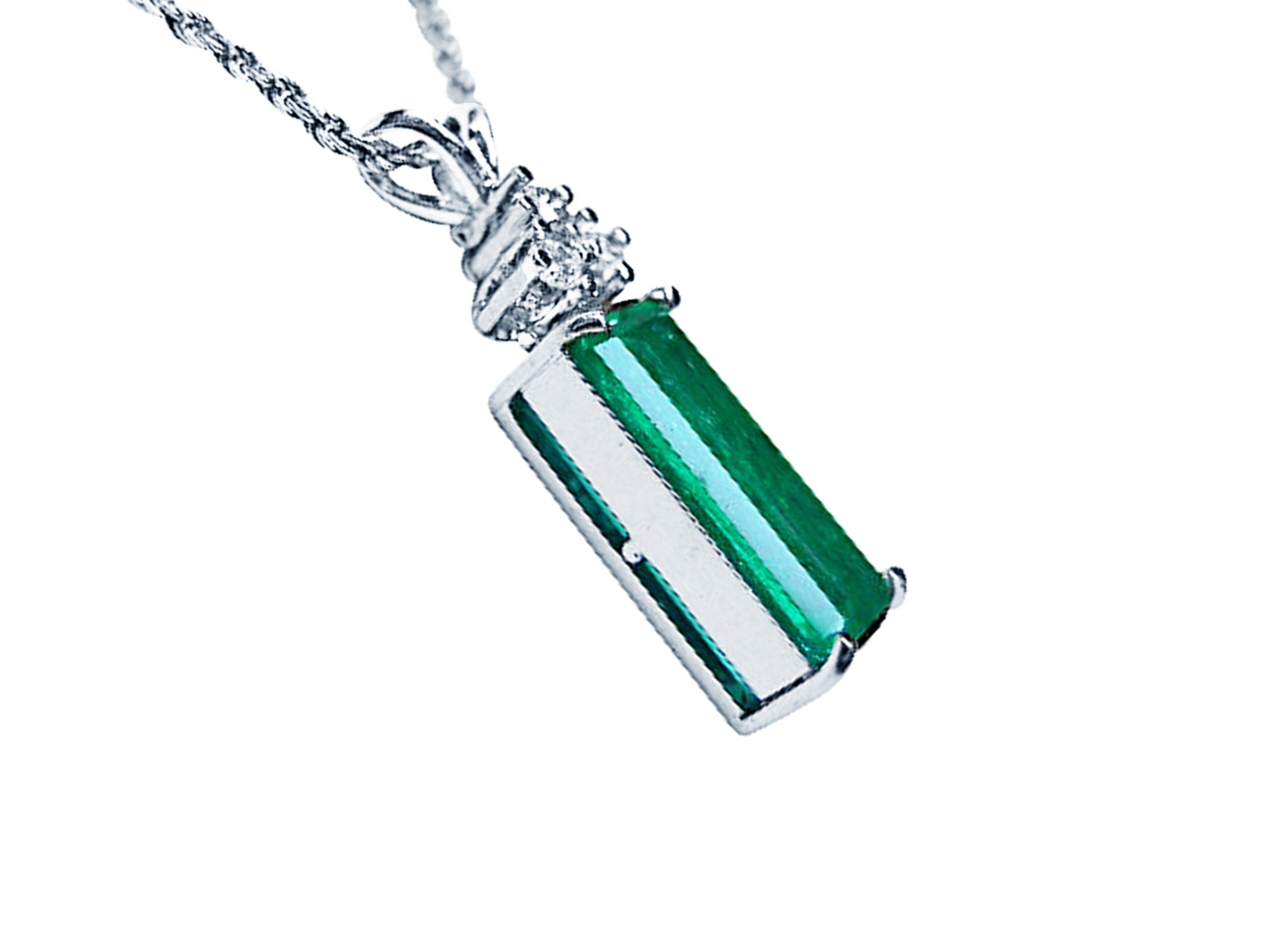 Right side profile of emerald pendant on a white gold chain against a white background