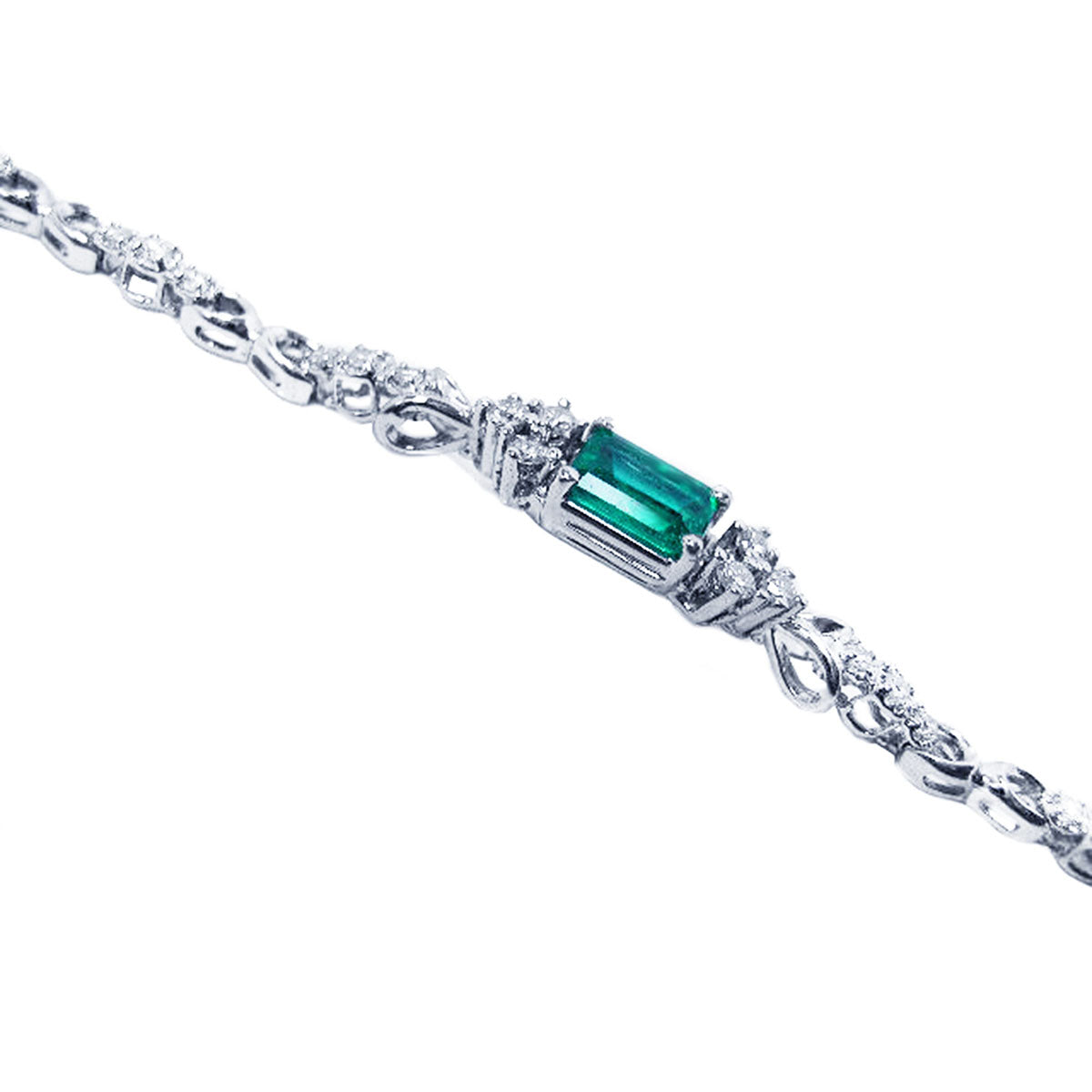 White gold bracelet with a rectangular emerald gemstone on a side profile position.