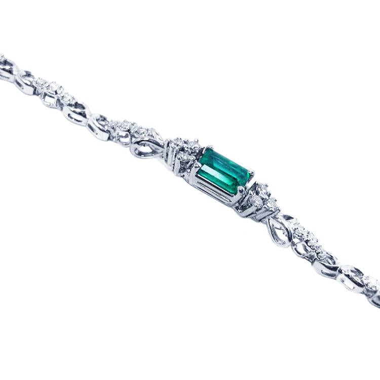 1.08 carat Muzo Colombian emerald bracelet, rectangular emerald-cut, deep bluish-green, with diamond accents in 14K white gold.