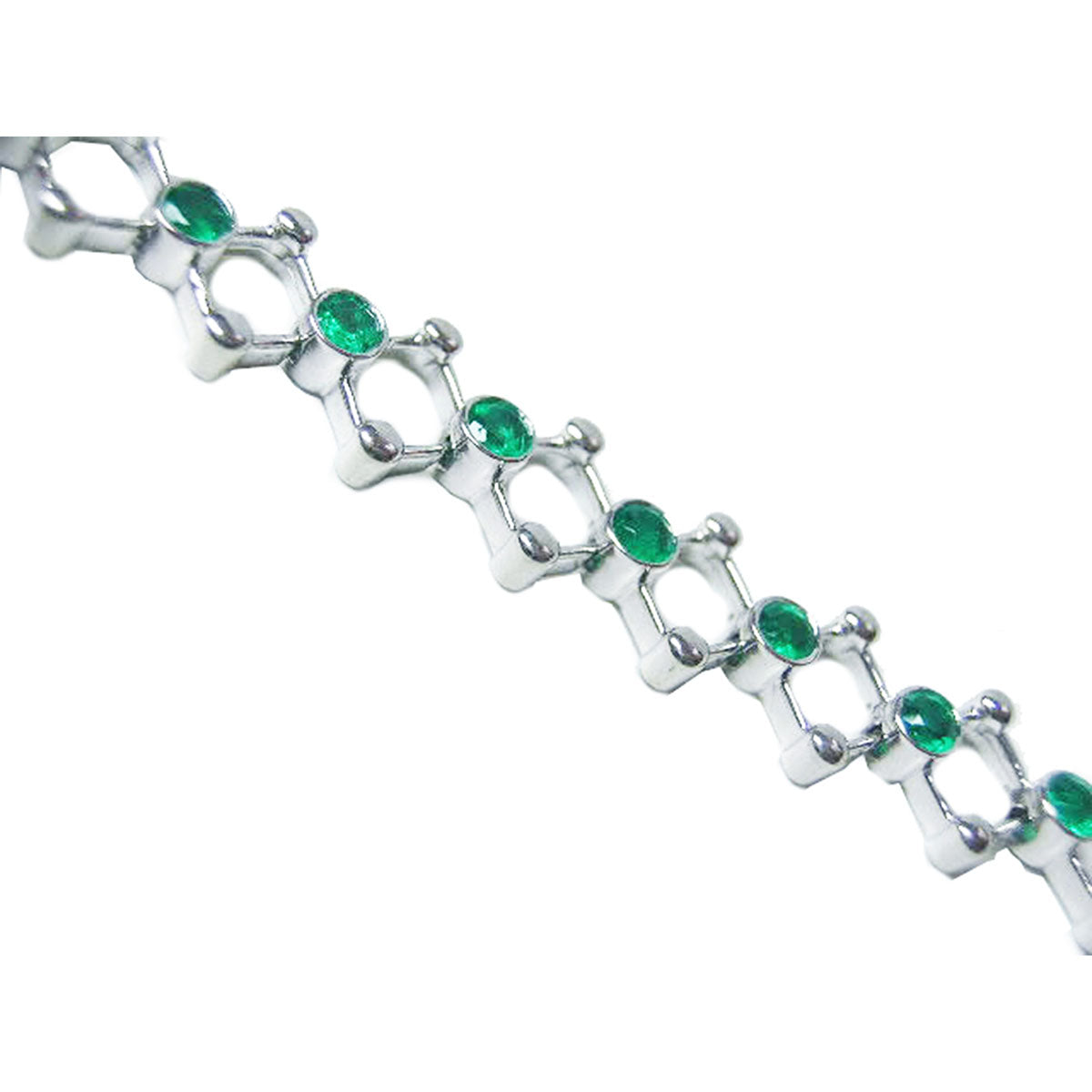 The side profile view of a white gold bracelet with round cut emeralds on a white background.