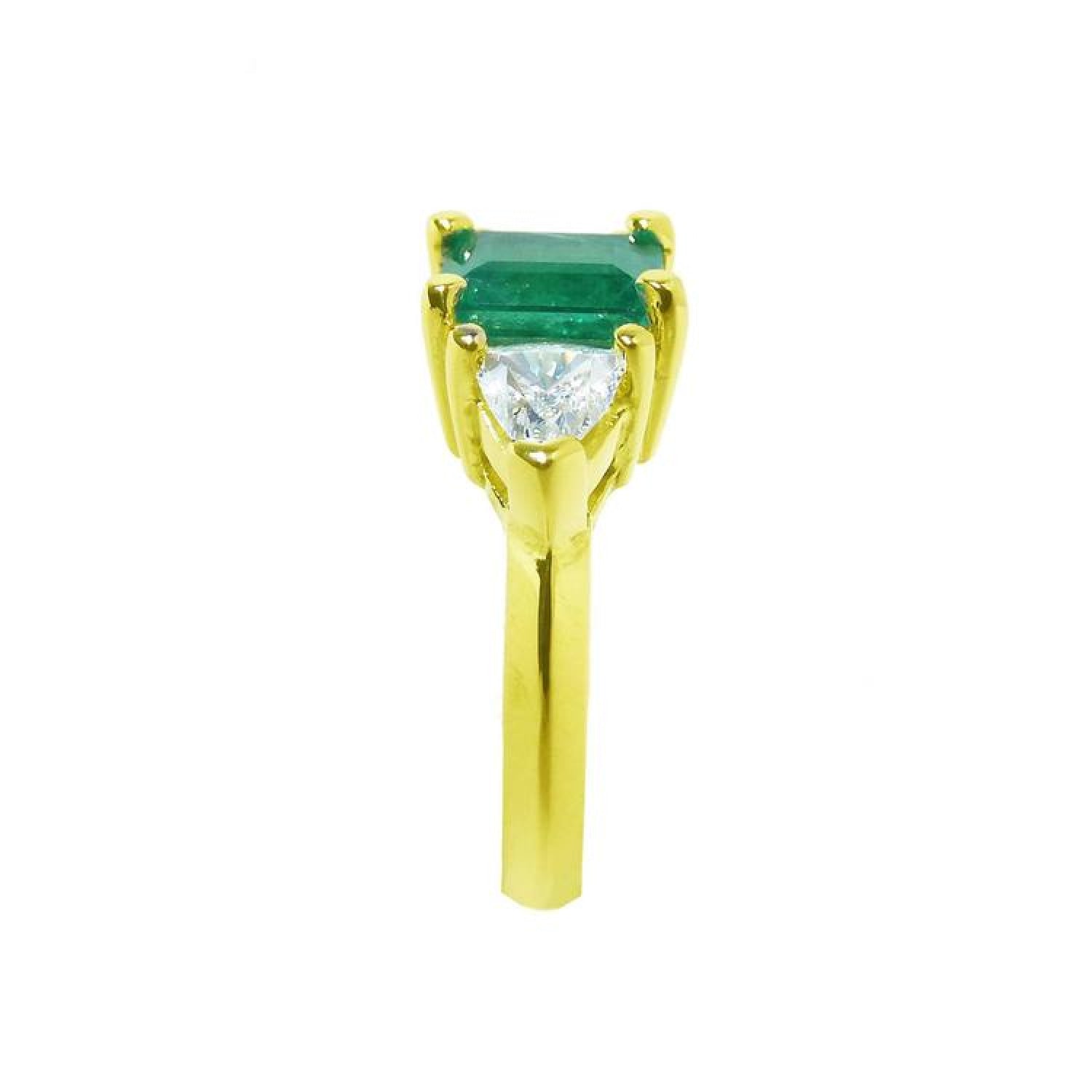 18K gold ring with a rectangular emerald center stone and trillion side diamonds.