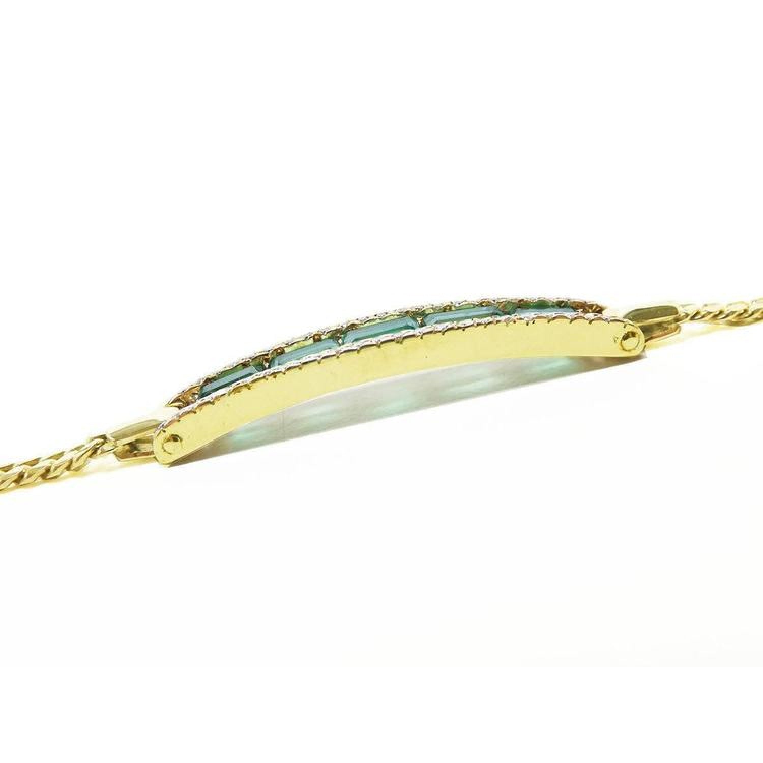 14K yellow gold bracelet with a curved bar featuring five rectangular bluish-green emeralds and small diamonds.