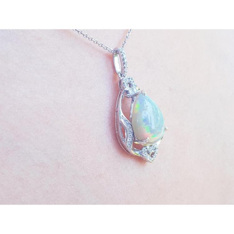 Pear-shaped rainbow Welo Ethiopian Opal pendant in 925 sterling silver with cubic zirconia accents.