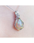 Opal pendant silver necklace on a person's neck with a white background.