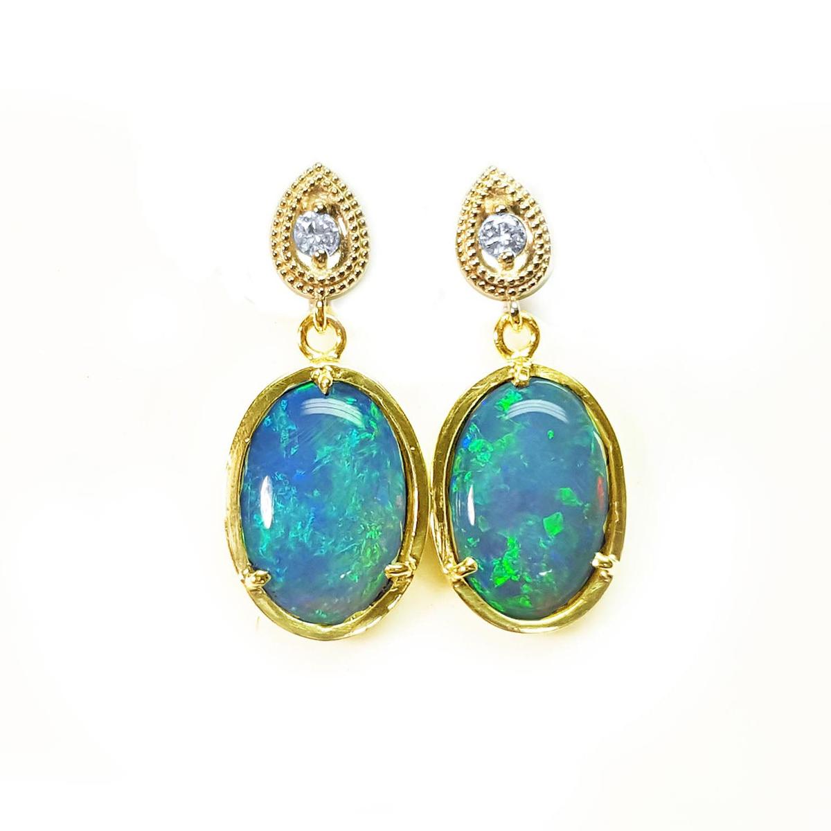 Australian opal earrings with gold setting on a topside view position.