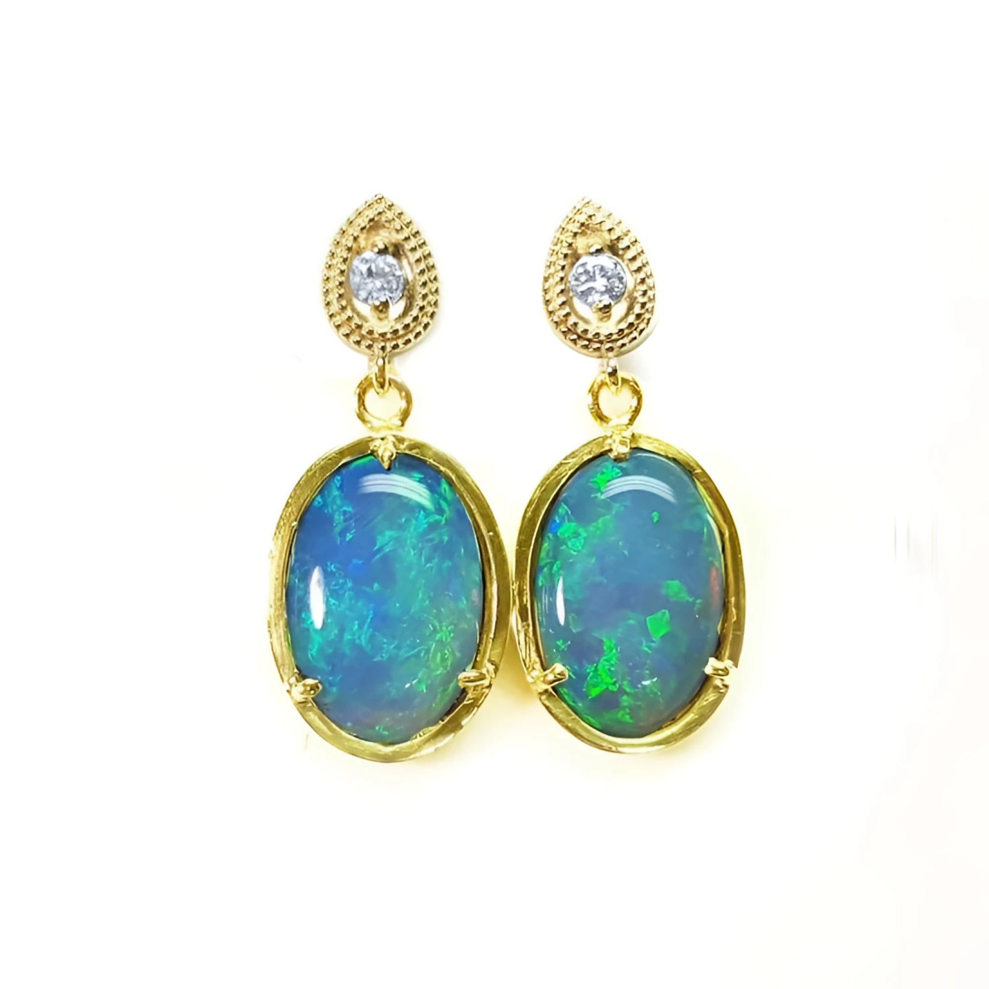 Bluish-green Australian opal earrings with dangling diamonds set in 14K yellow gold.