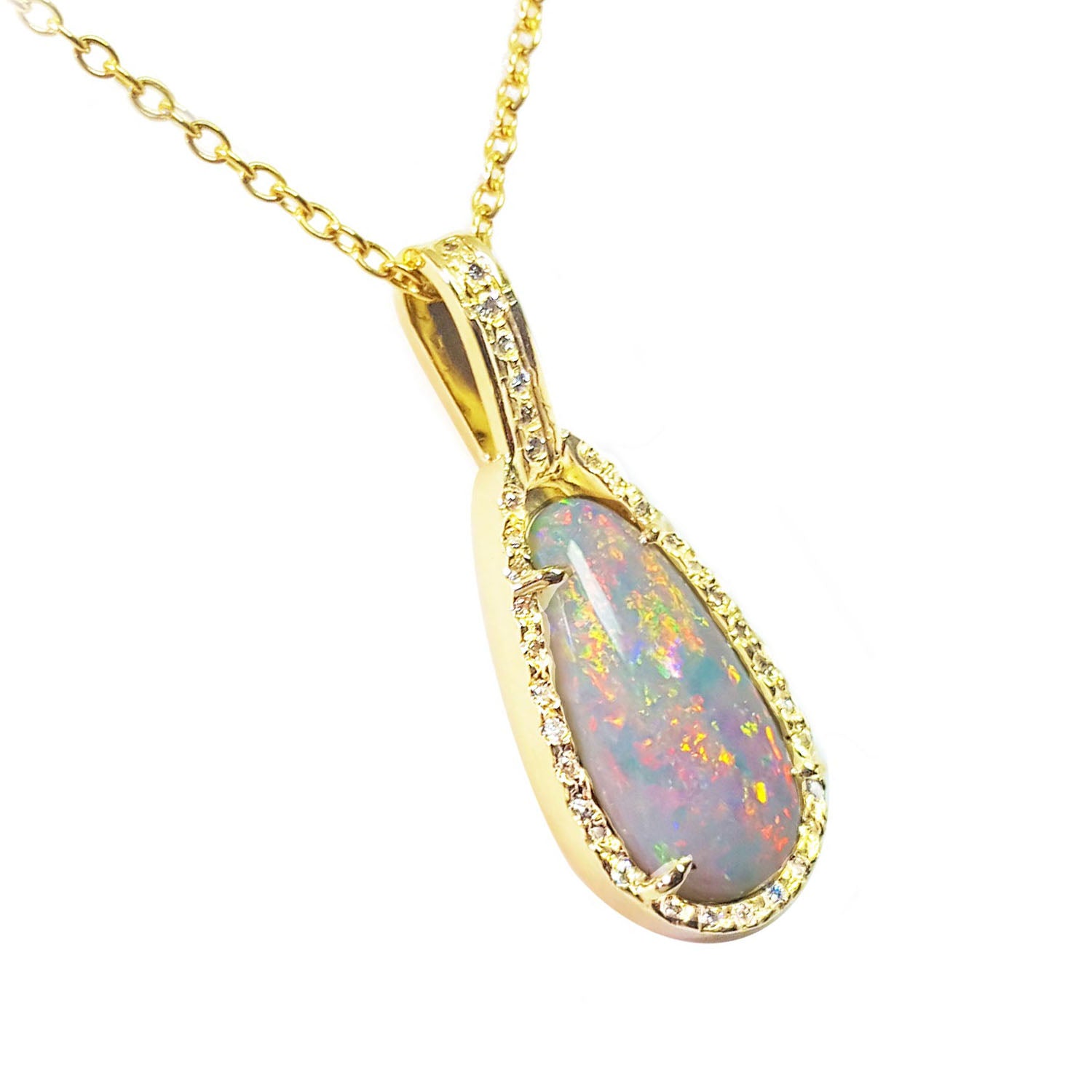Opal pendant necklace with gold chain on a right-side profile view.