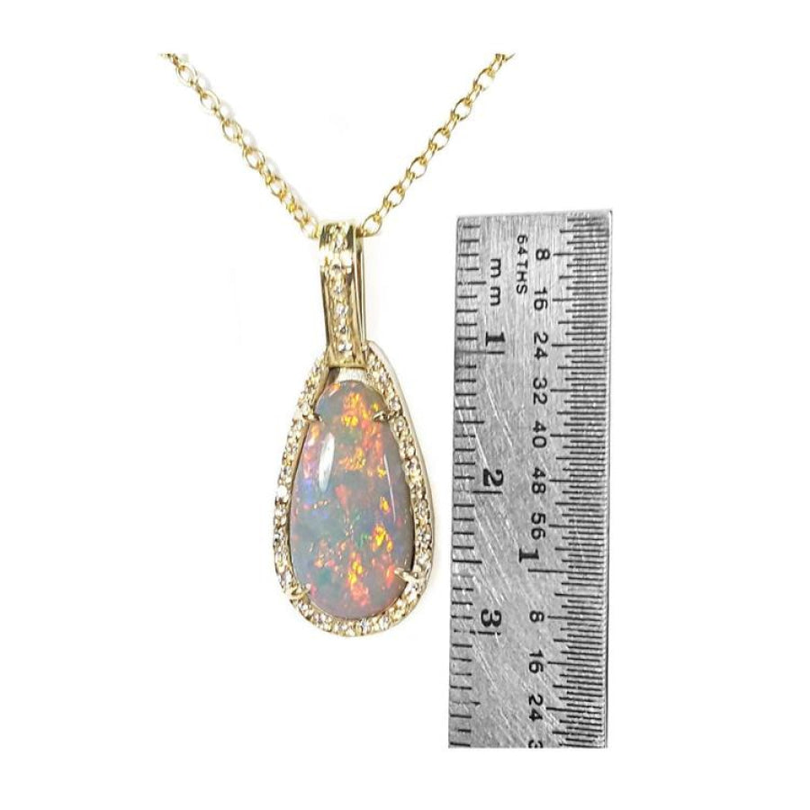 4.30 ct. solid Australian opal pendant with fiery red-orange flashes, halo diamonds, and 18K yellow gold chain.
