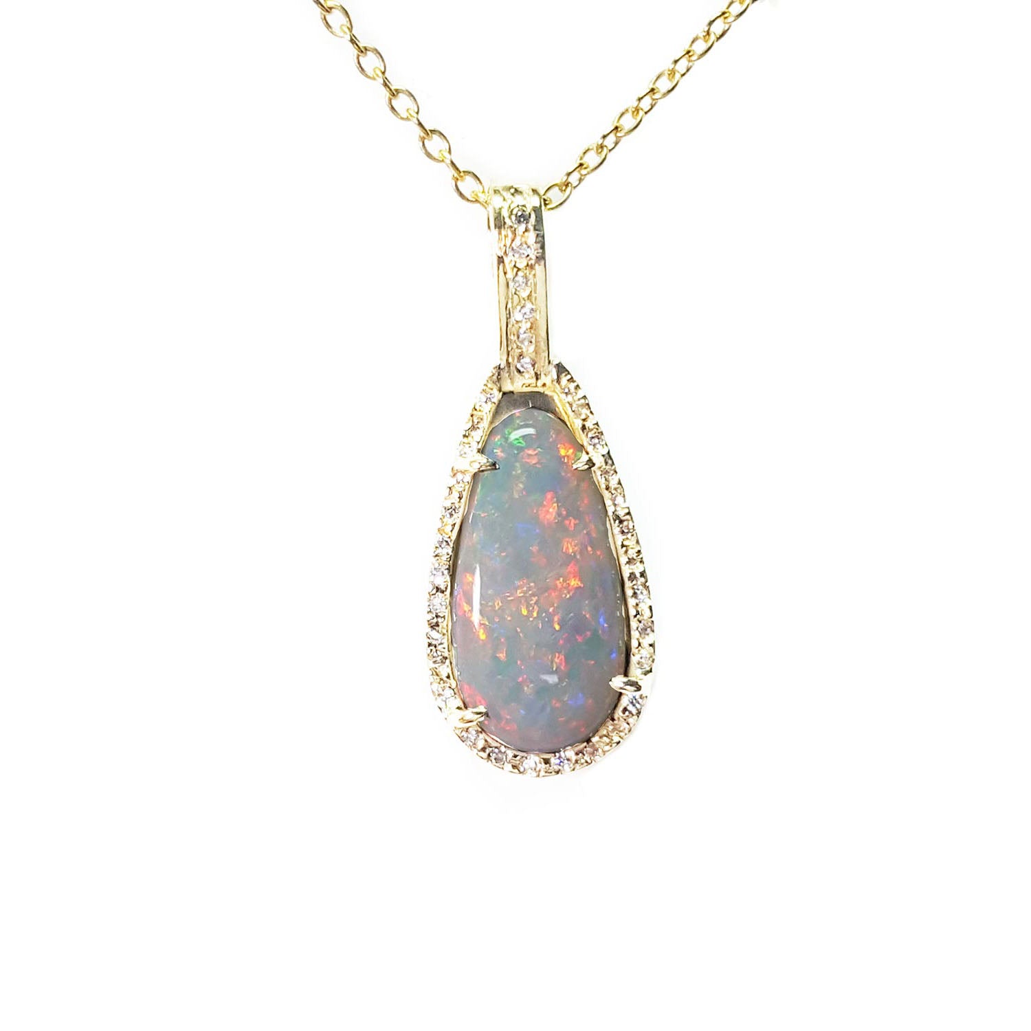 An Australian opal pendant necklace with gold chain showing the pear shaped gold and diamonds frame.