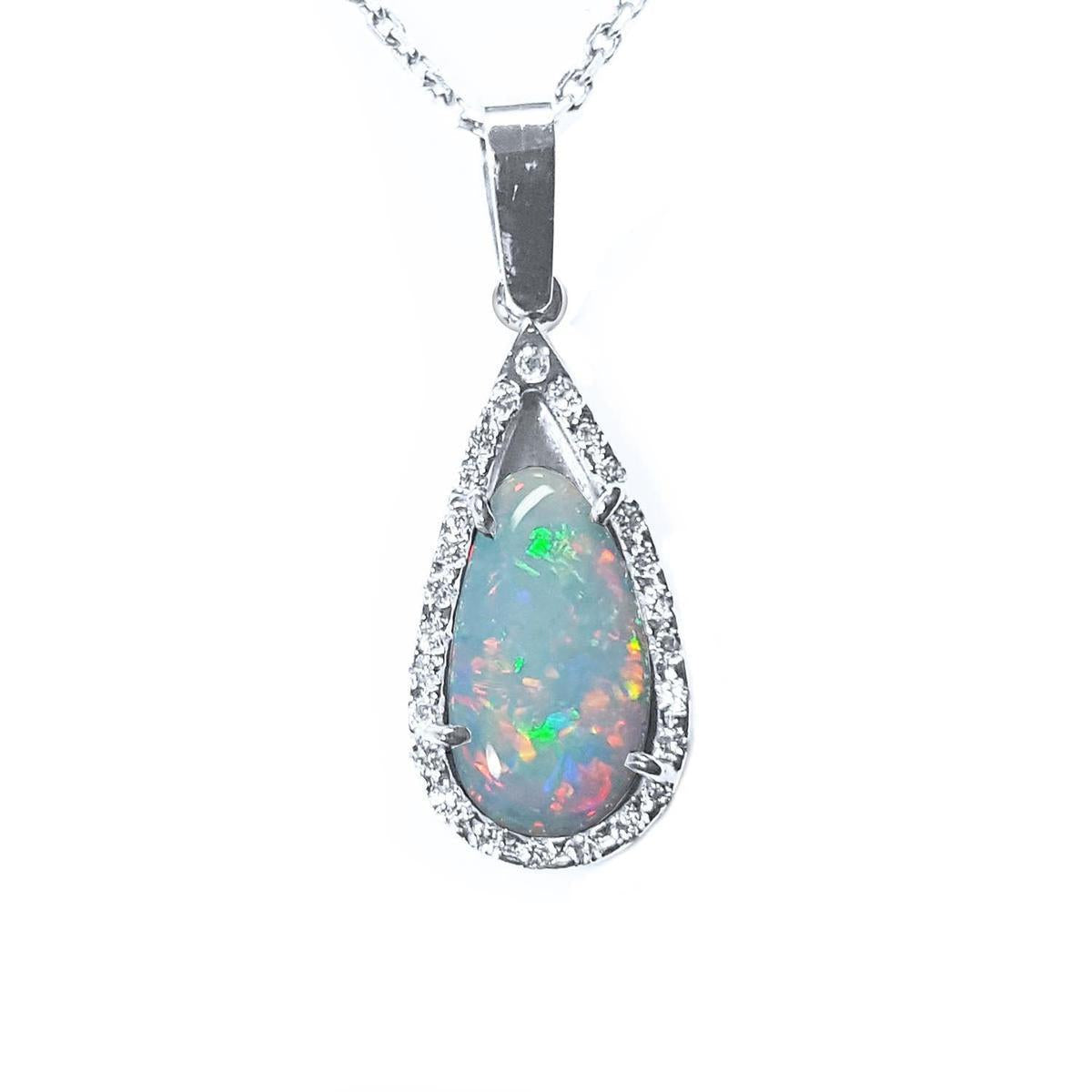 This pear opal pendant necklace displays a white gold and diamond frame on a topside view.