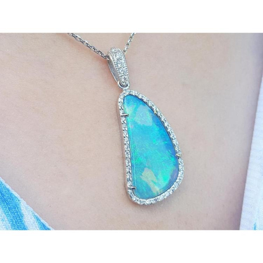 Australian opal pendant with blue-green play of color, halo diamonds, and 18K white gold chain.
