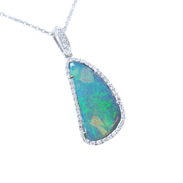 A solid Australian opal pendant necklace on a white gold and diamond frame displaying the topside.
