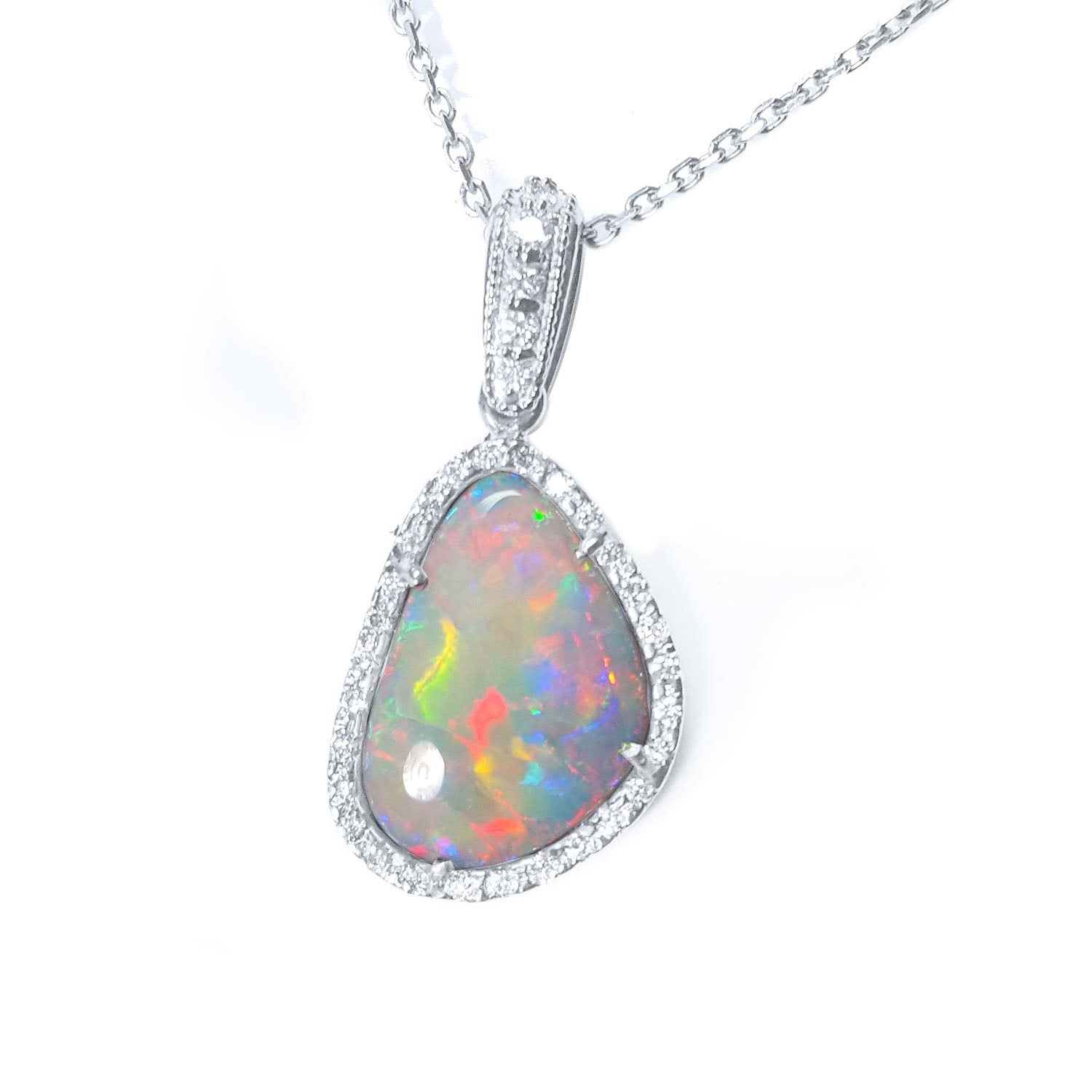 A natural solid Australian opal pendant halo diamond white gold necklace on a topside view.