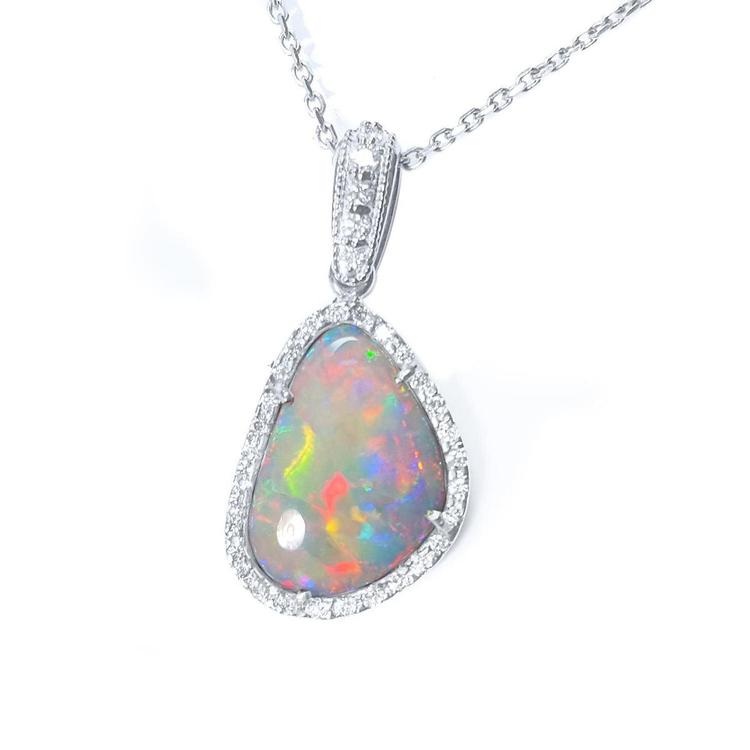 A natural solid Australian opal pendant halo diamond white gold necklace on a topside view.