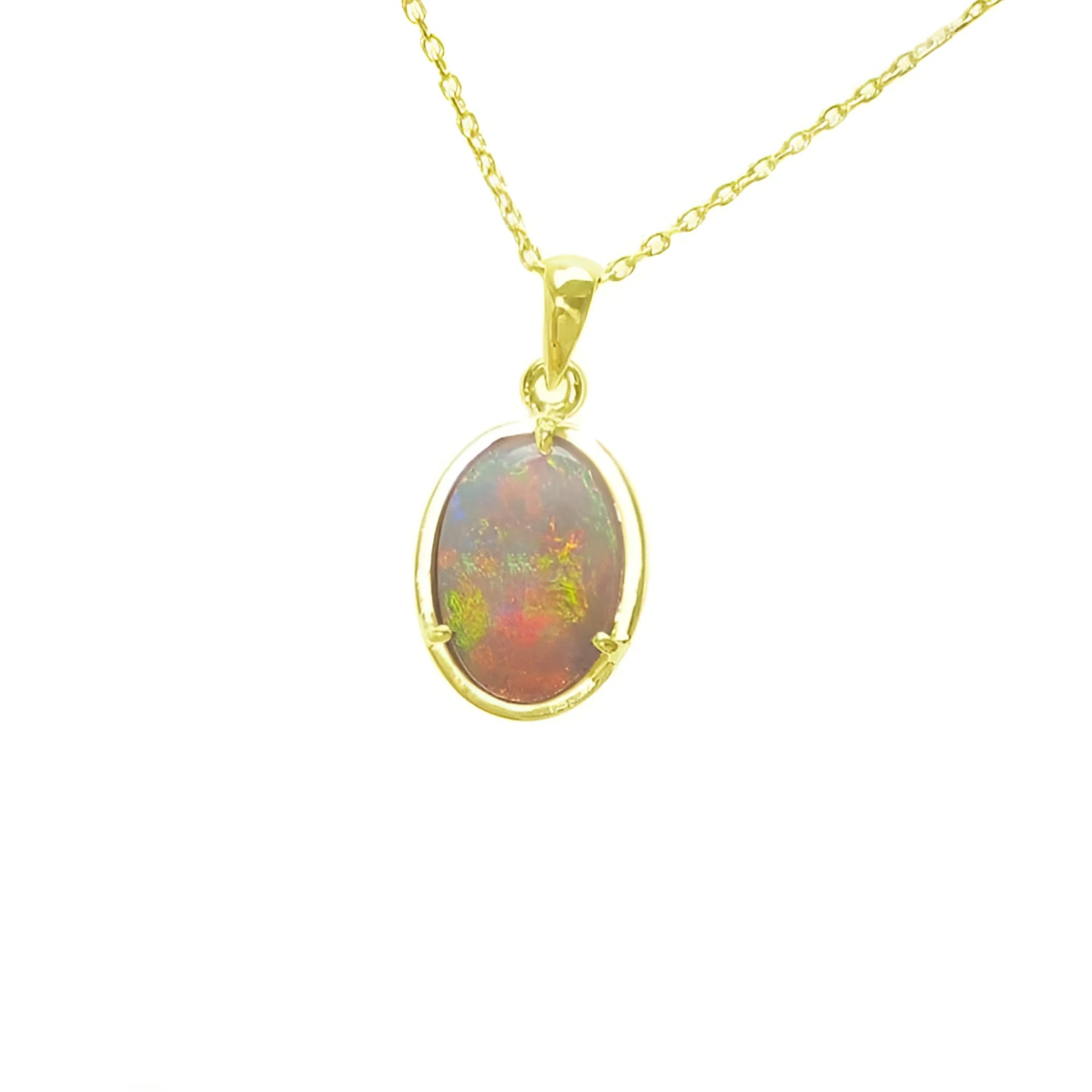 Oval Australian opal pendant with red and green fire, set in 14k yellow gold on a delicate chain.