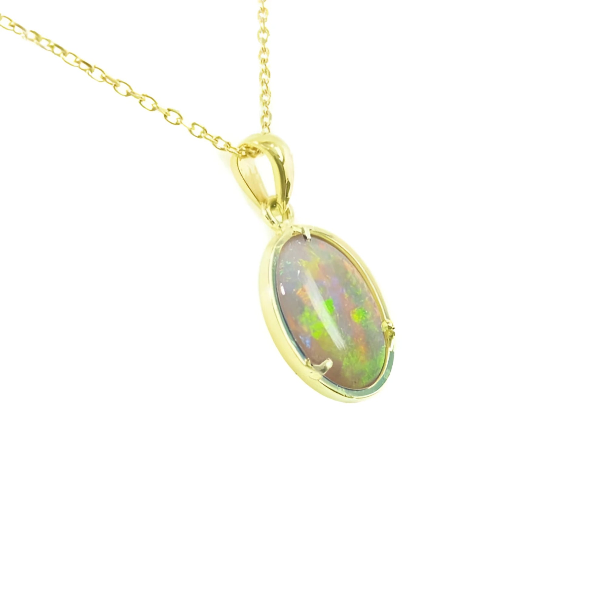 Oval solid white Australian opal pendant with vibrant play-of-color, set in 14k yellow gold on a delicate chain.