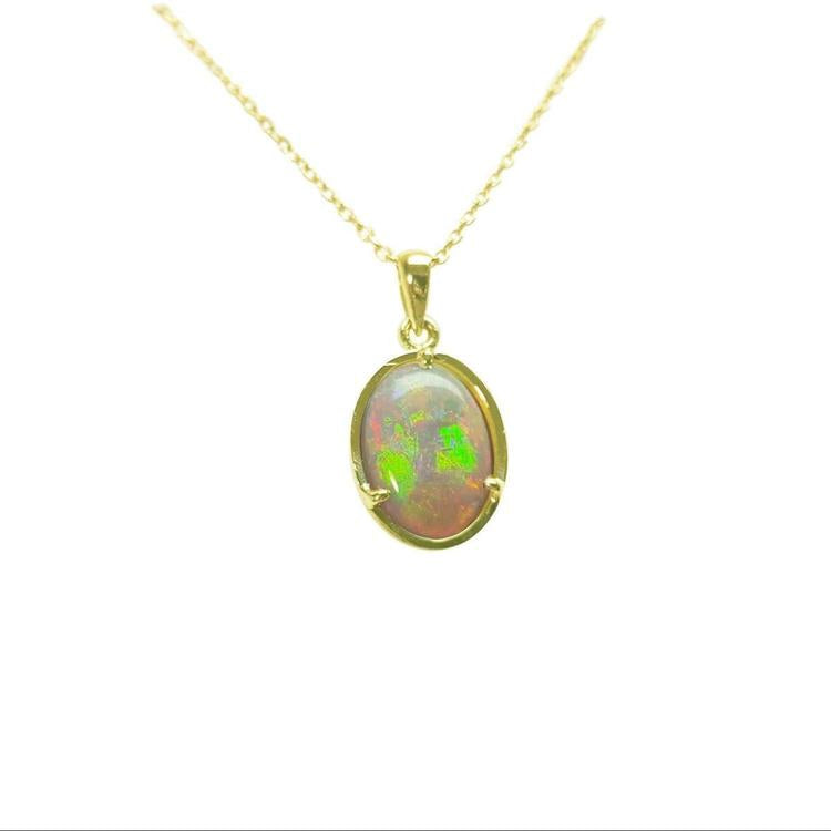 Opal pendant necklace on a gold chain against a white background