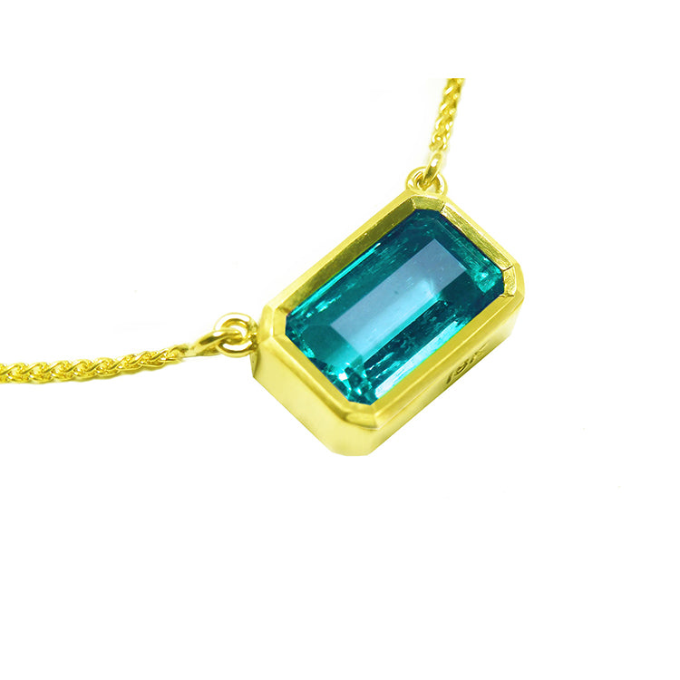 Natural emerald solitaire necklace bezel set east-west orientation handcrafted in 18k yellow gold