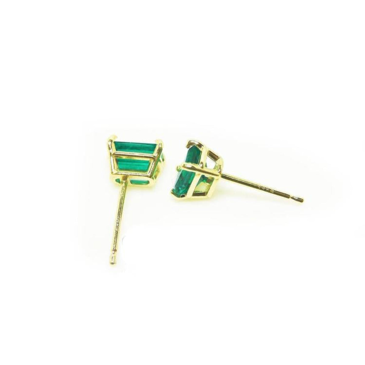Pair of emerald cut emerald stud earrings in 14K yellow gold basket settings with push backs.