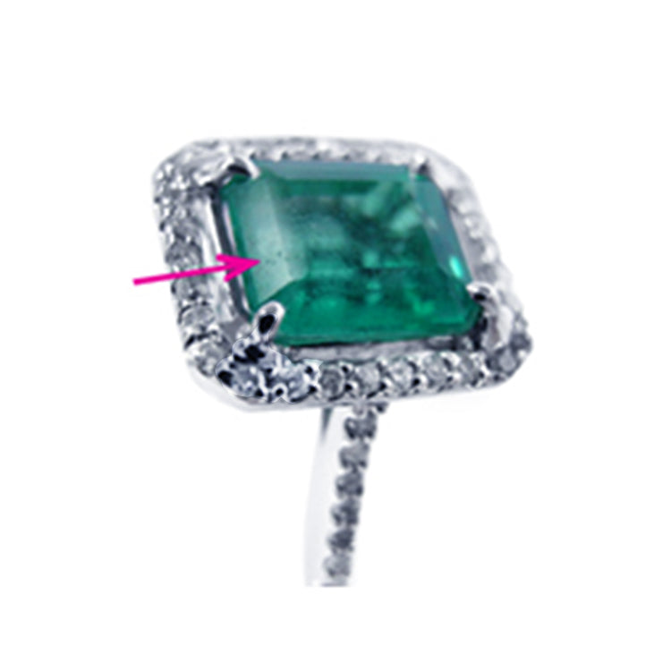 spotting a surface reaching natural flaw pore on emerald gemstone 