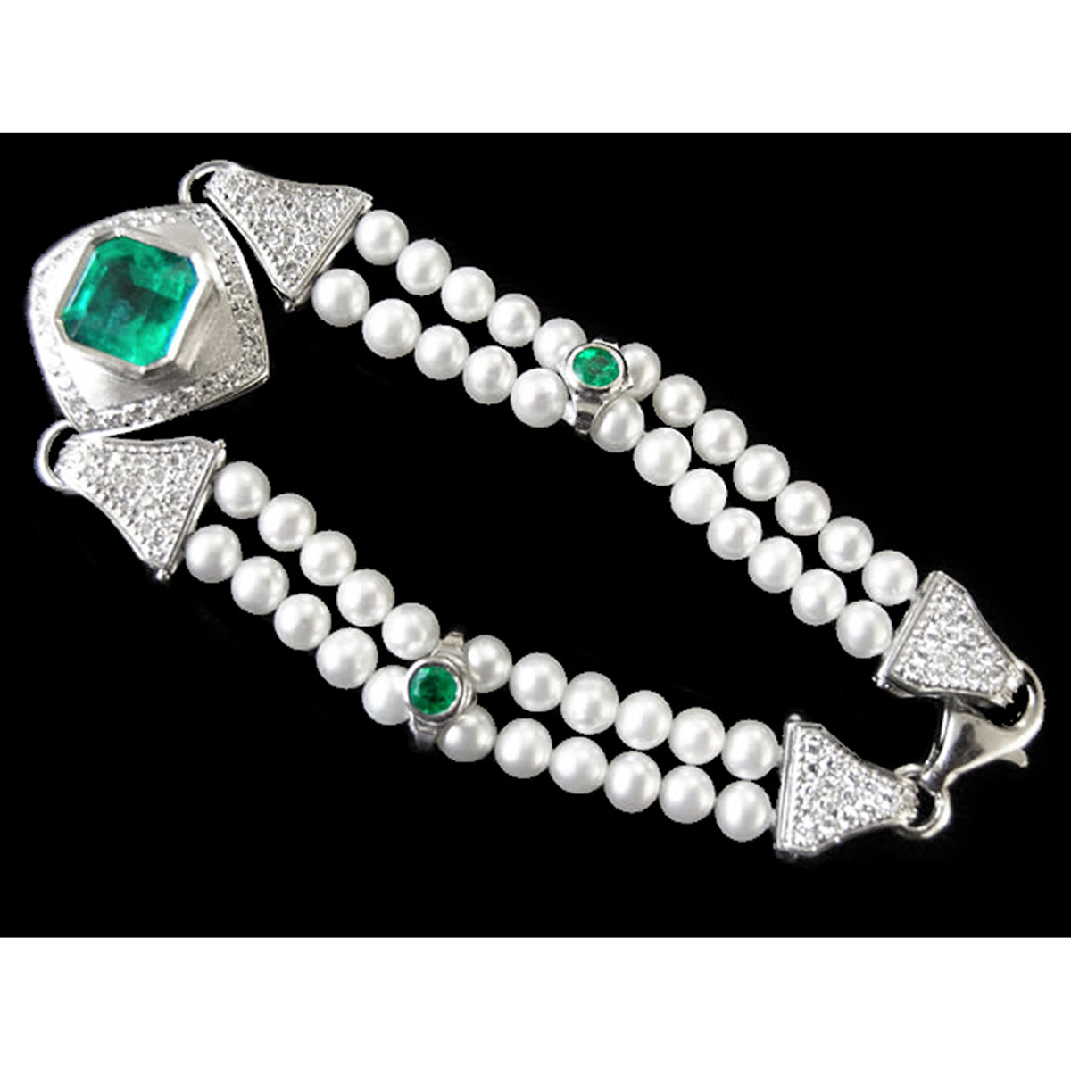 Pearl bracelet with emerald and diamond accents on a black background