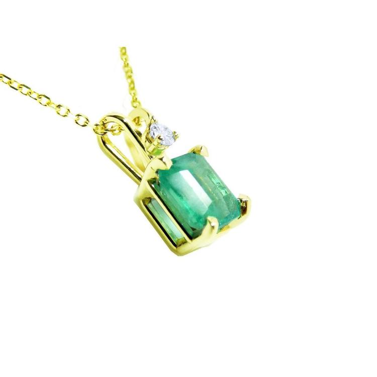 Gold pendant with a genuine colombian emerald on its right-side position, top and gallery visibles.