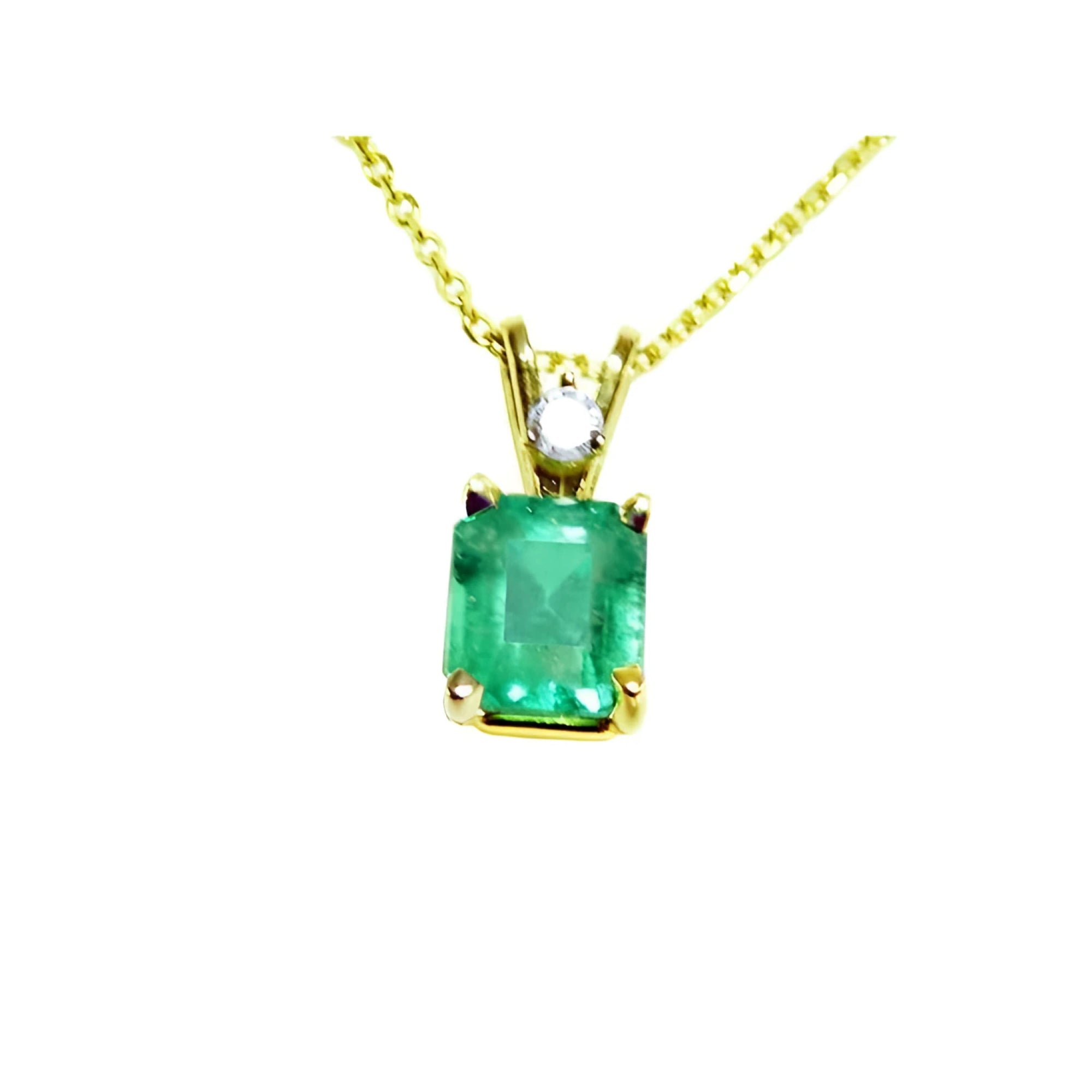 This natural emerald-cut colombian emerald pendant made of yellow gold is showing its topside.