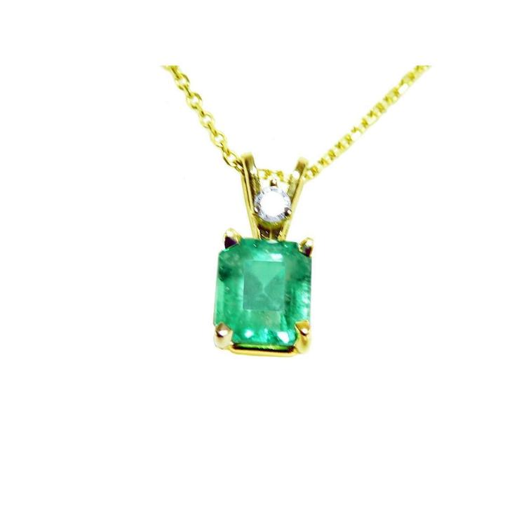 This natural emerald-cut colombian emerald pendant made of yellow gold is showing its topside.