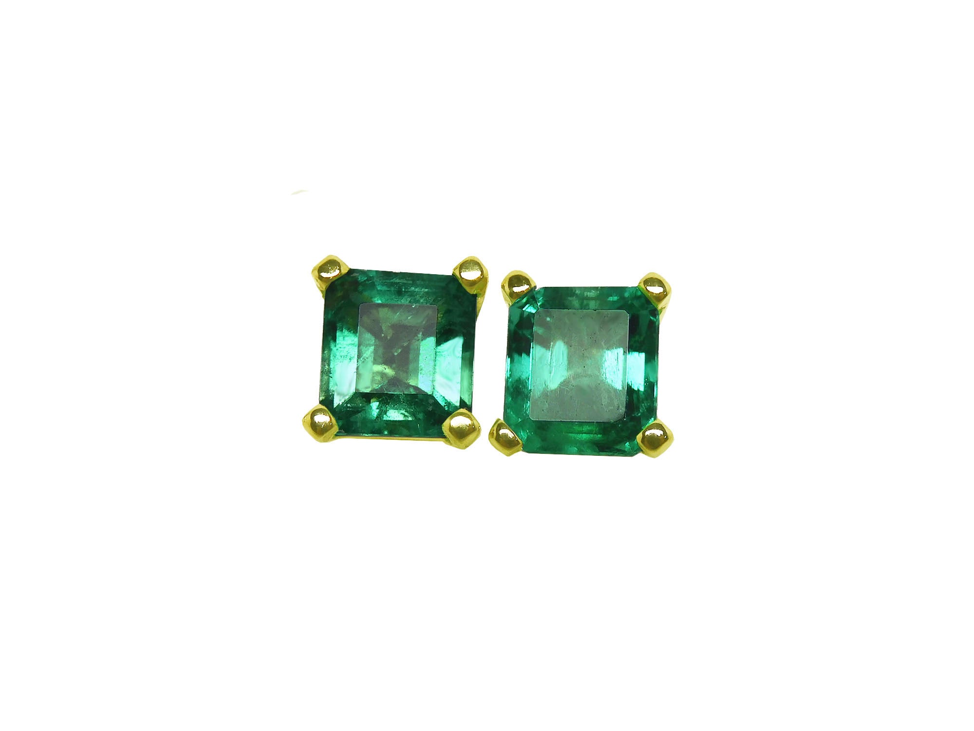 A pair of natural emerald stud earrings square cut, top side table and crown visibles.