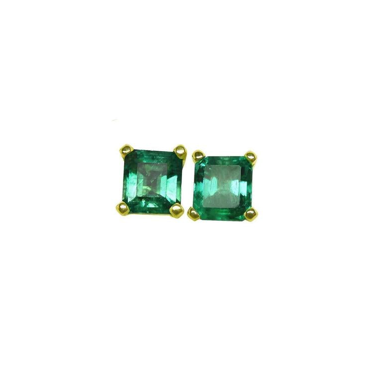 Pair of square emerald stud earrings in 14K yellow gold with basket settings.