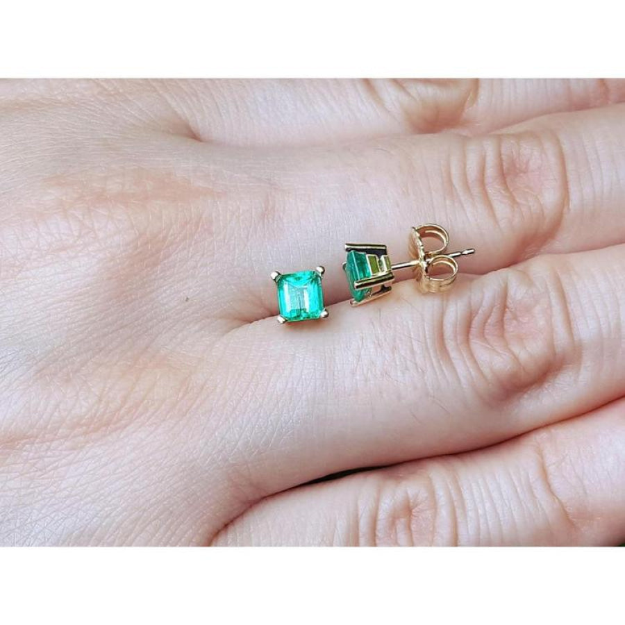 Square emerald stud earrings in 14K yellow gold, featuring octagonal cut green emeralds.
