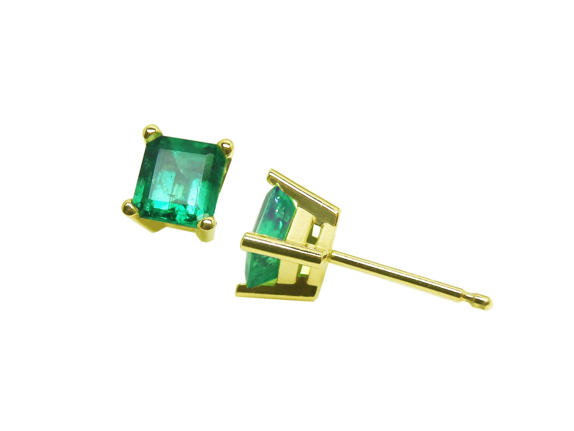 A pair of 14K gold emerald stud earrings placed on a front and side positions profile&#39;s view.