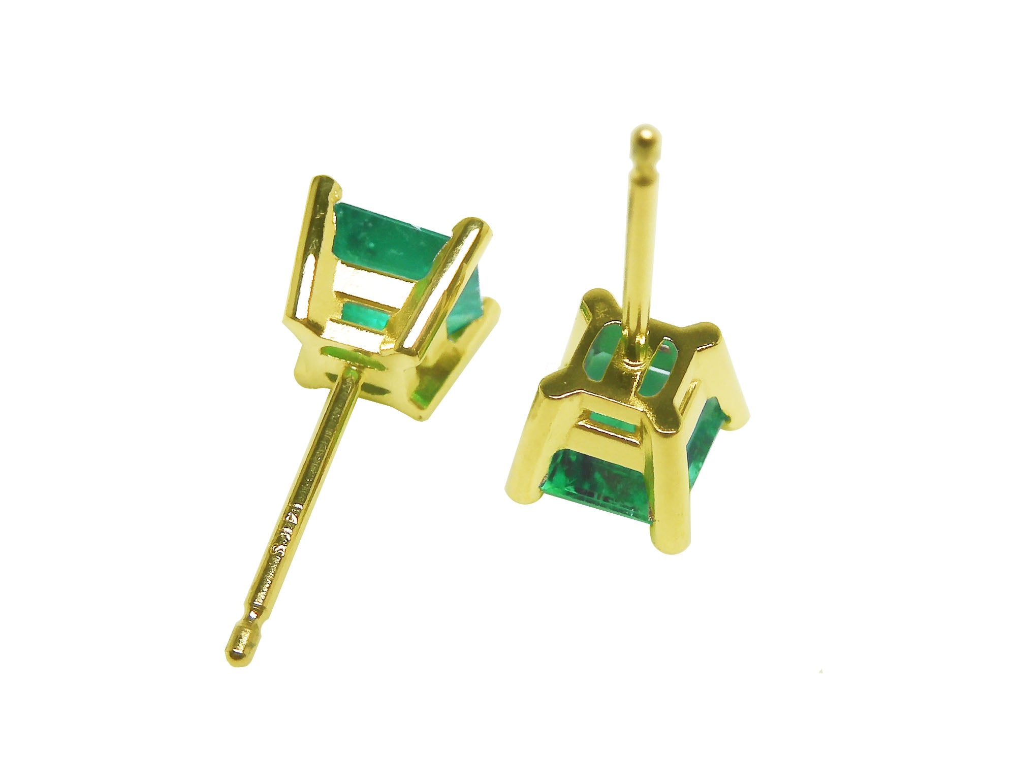 A pair of yellow gold emerald stud earrings in 14k yellow gold upside down downside visibles.