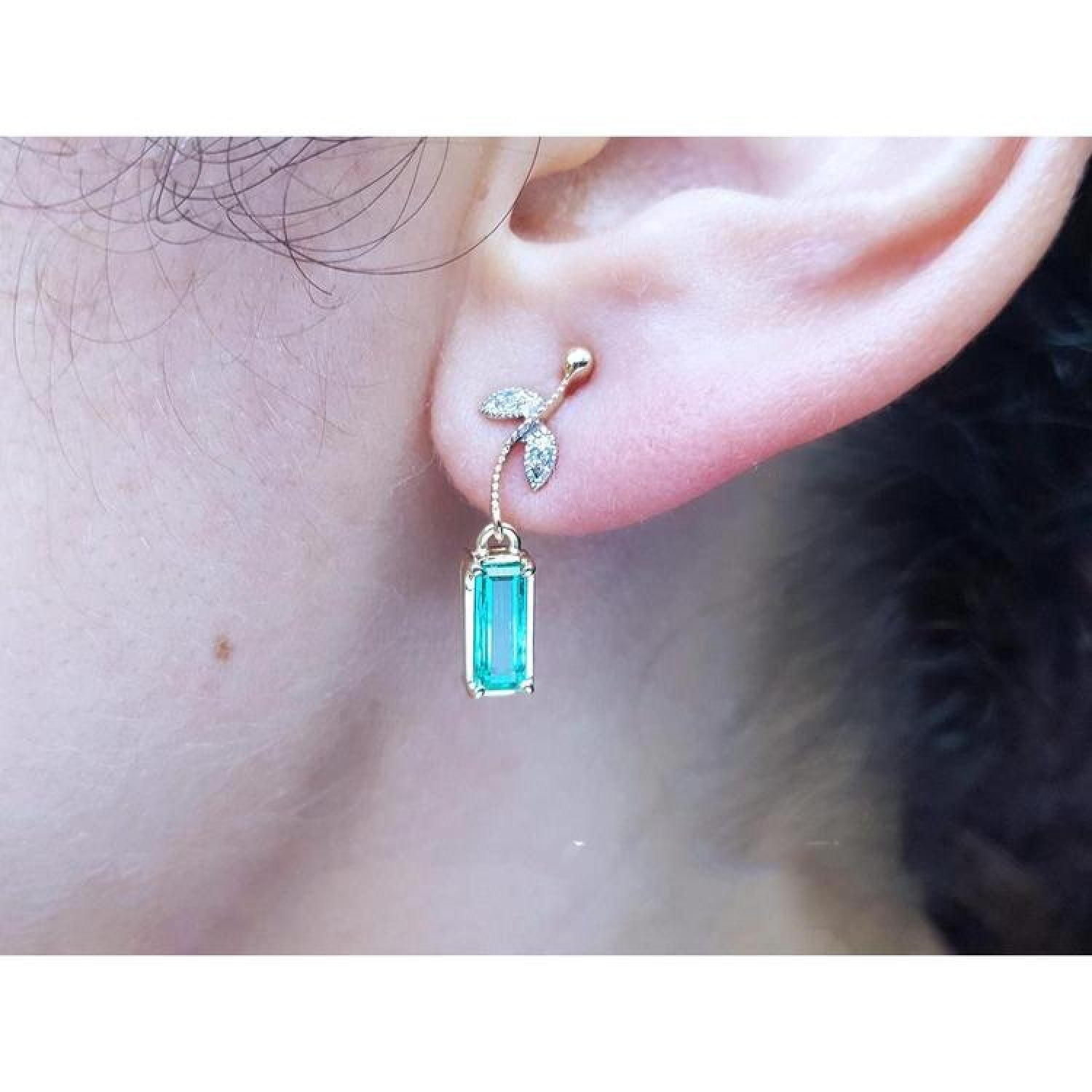 14K gold stud emerald leaf earrings with vibrant medium green rectangular emeralds and diamond accents.